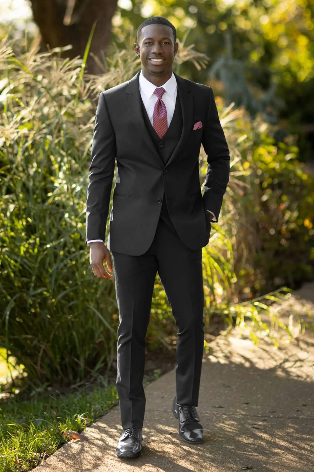 model is wearing a black tuxedo