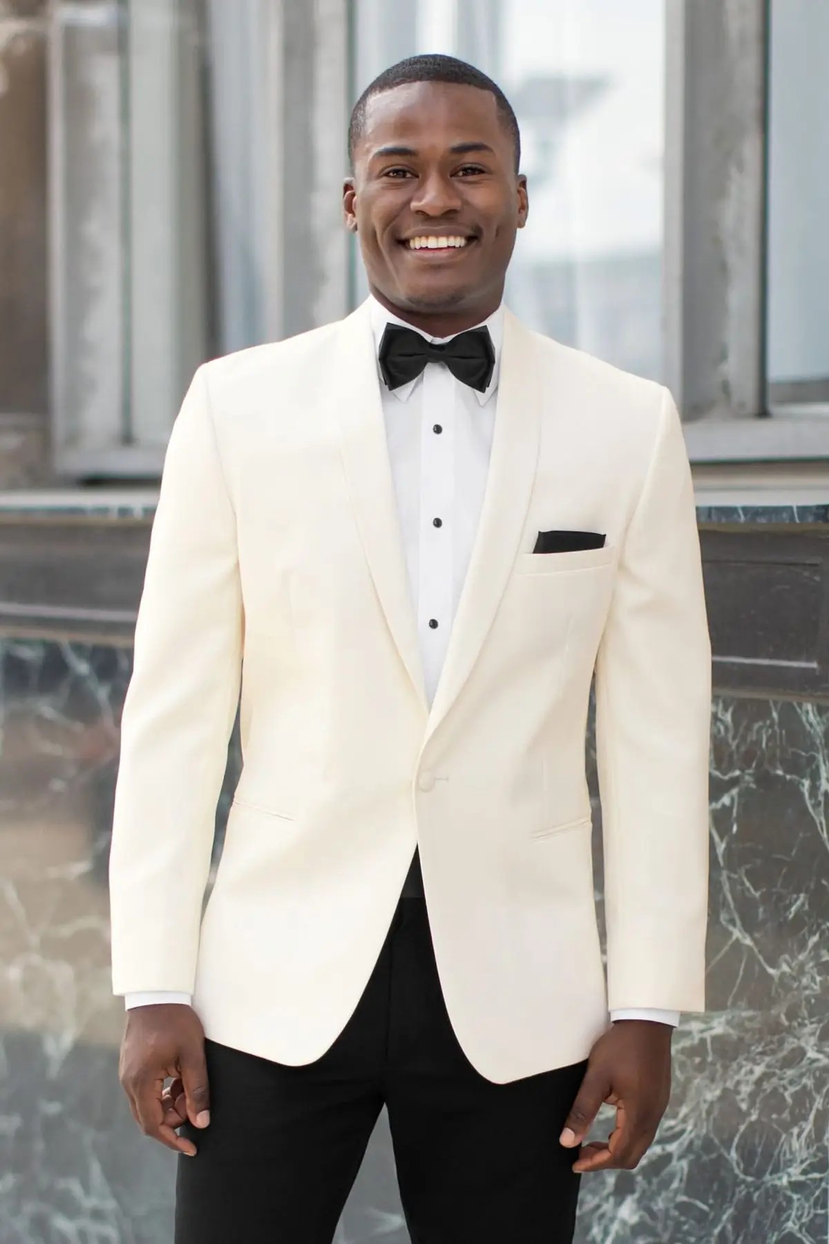 model is wearing a white suit jacket with black dress pants