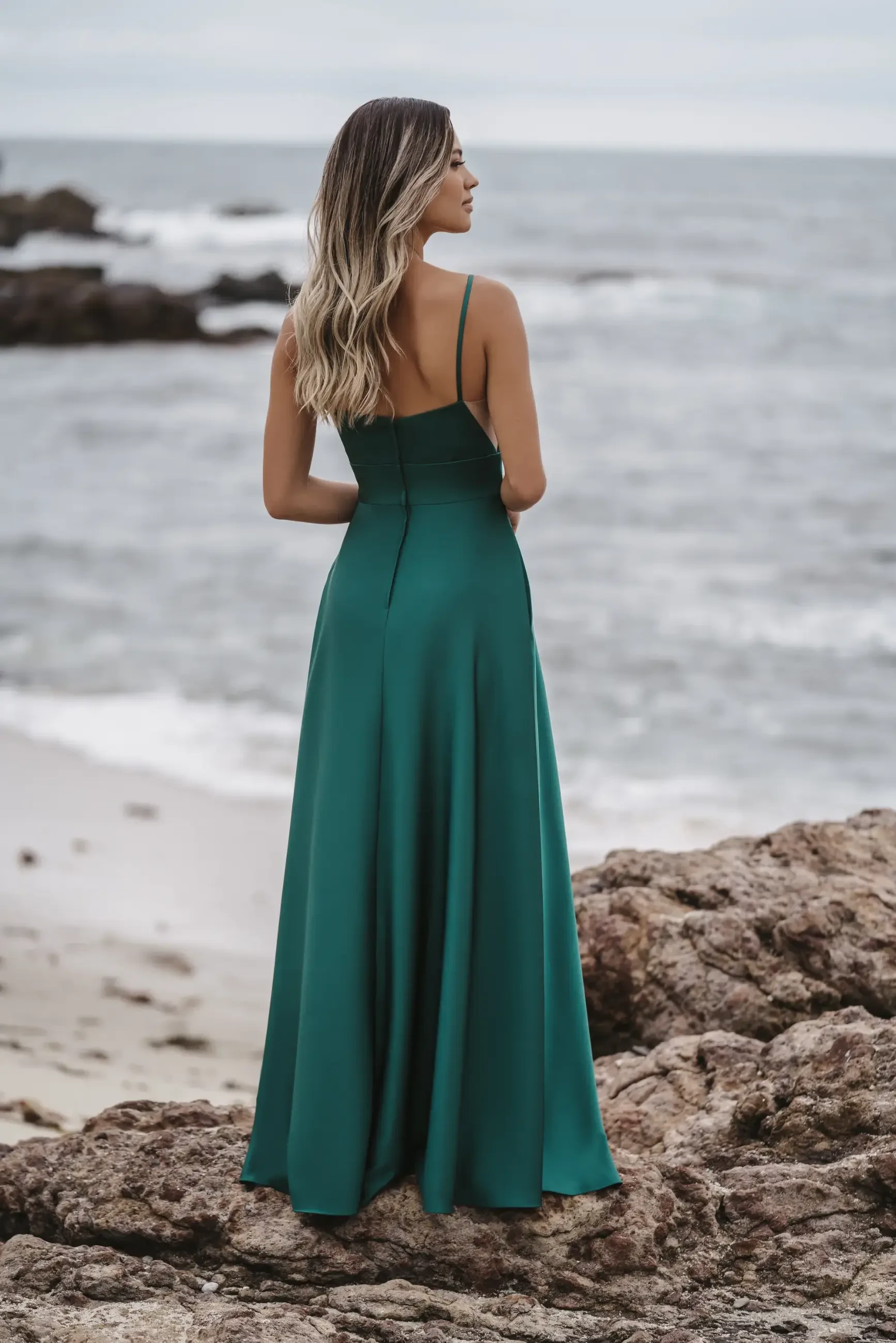 model is wearing a sleeveless green a-line bridesmaid dress