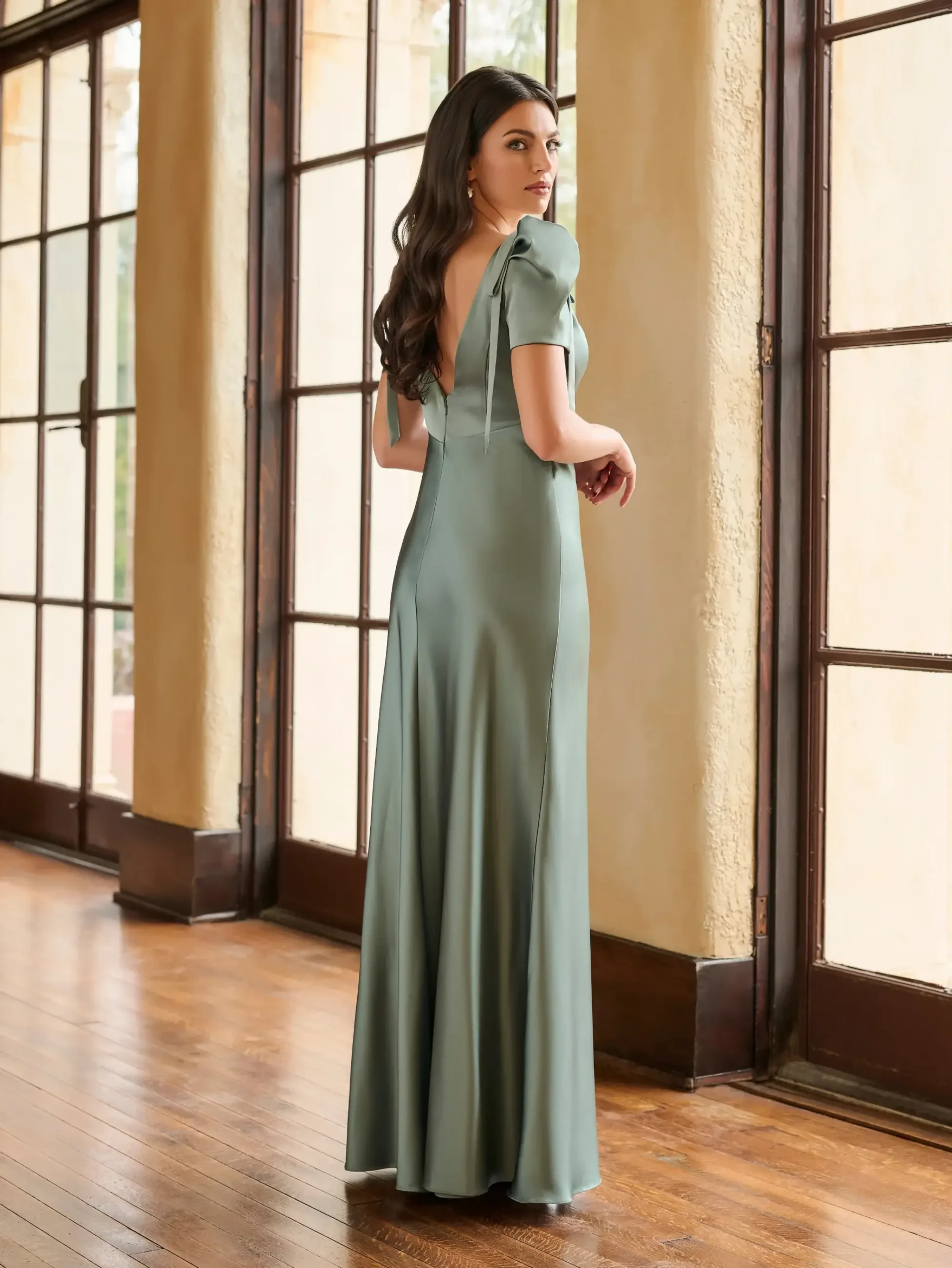 model is wearing a sage green bridesmaid dress