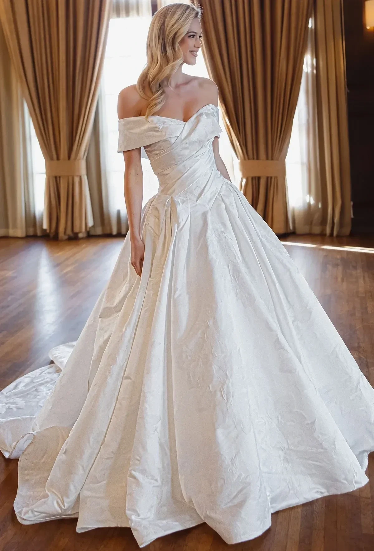 Model wearing a gown by essense of australia