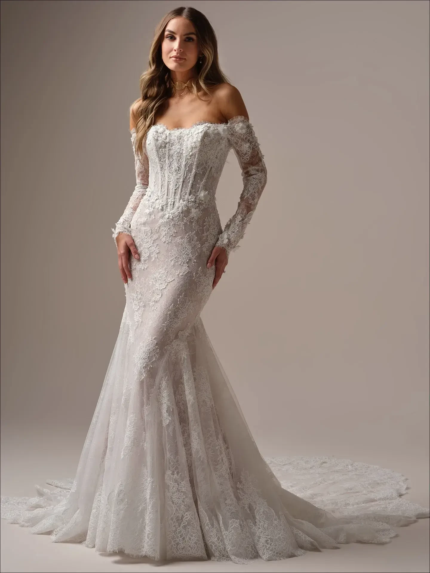 model is wearing a long sleeve lace mermaid wedding dress by maggie sottero